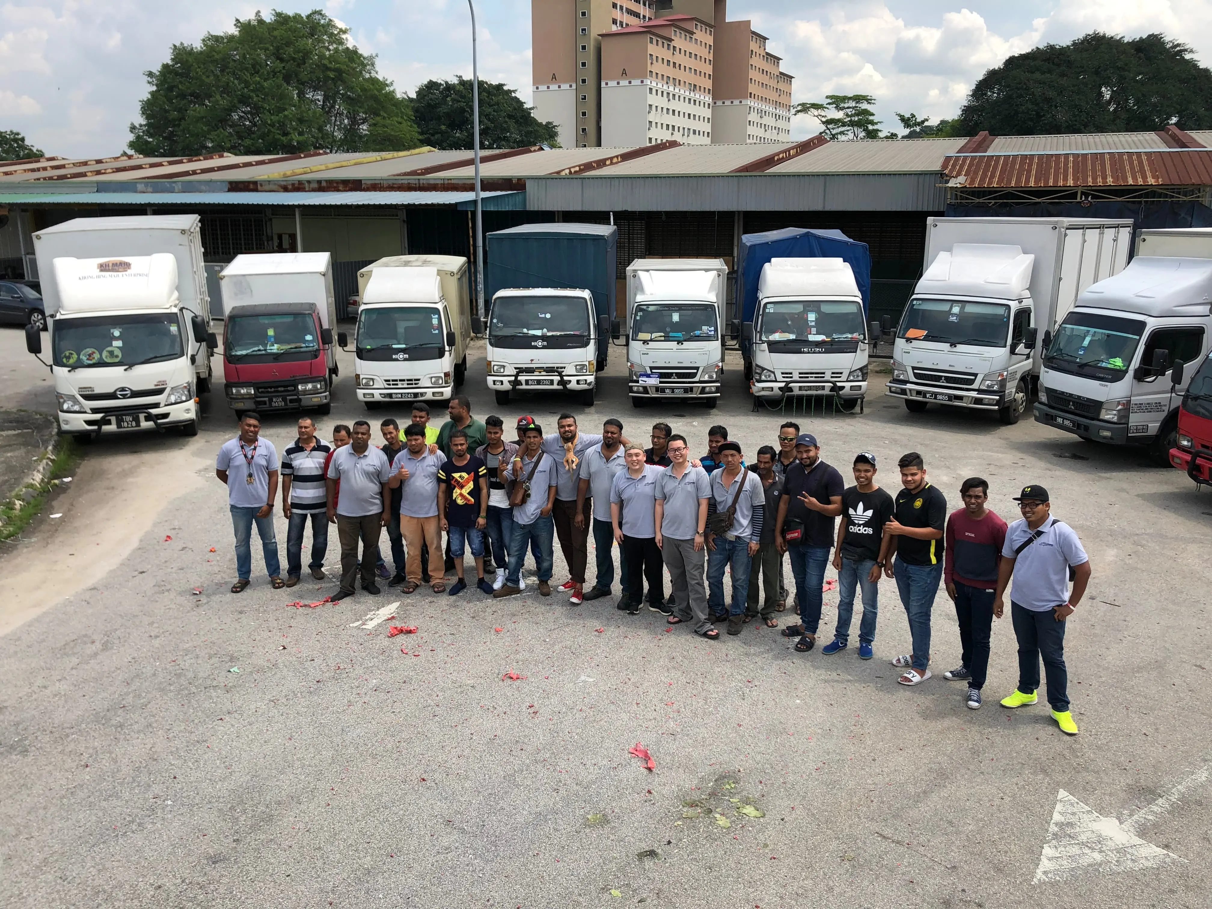 Mileford team standing in front of their lorry fleet, ready for logistics operations.
