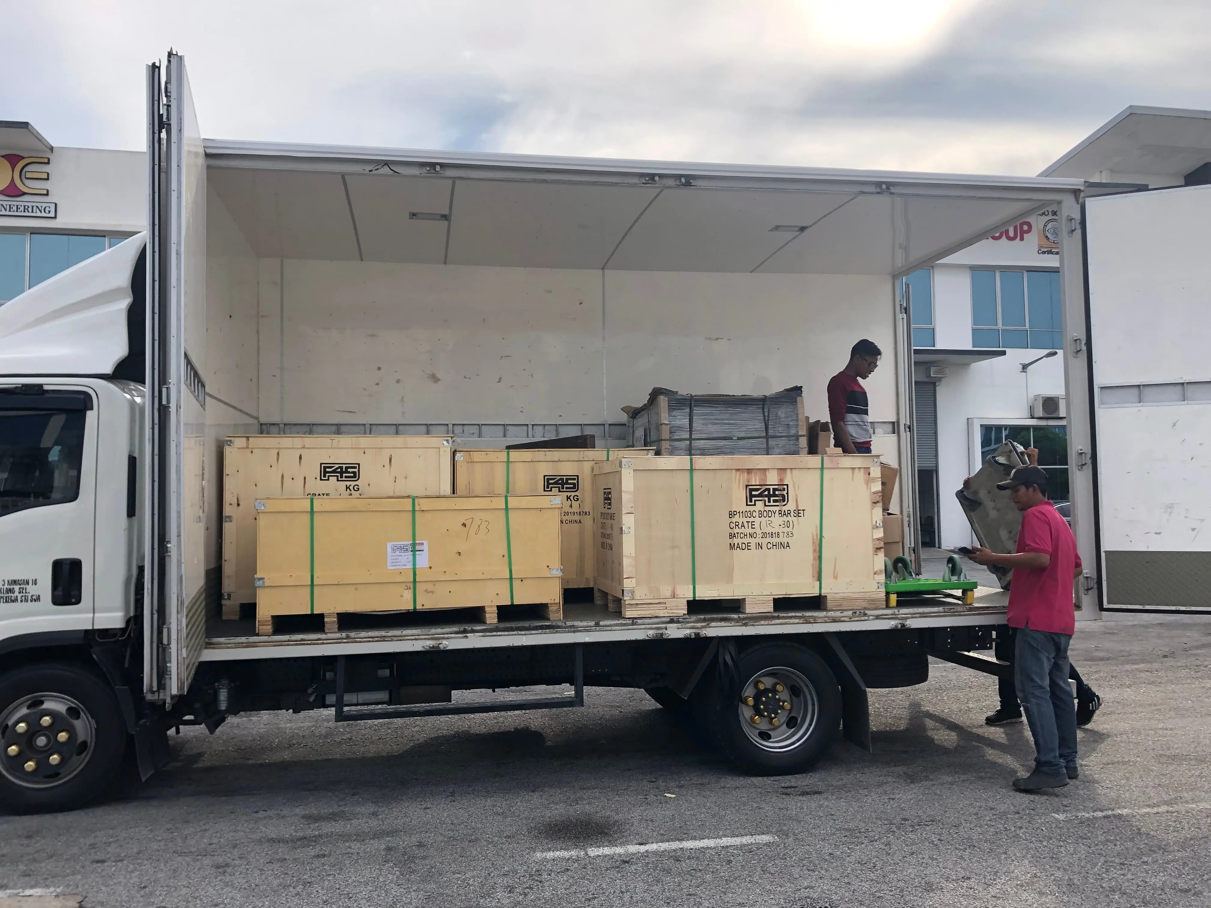 Mileford staff loading large wooden crates into a lorry using a forklift, showcasing expert handling of specialized cargo.